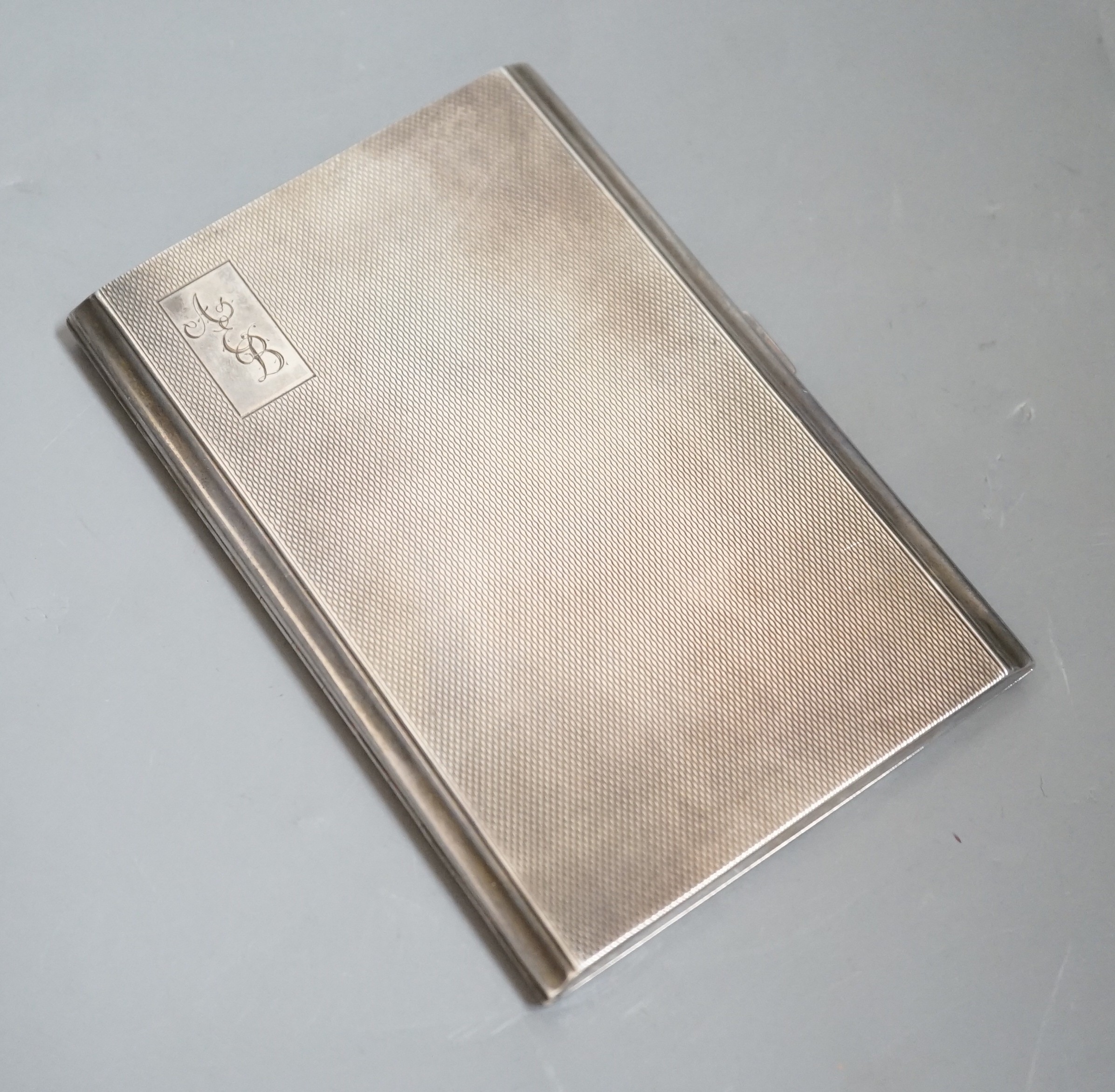 A George V engine turned silver rectangular cigarette case, 12.2cm, with engraved initials.